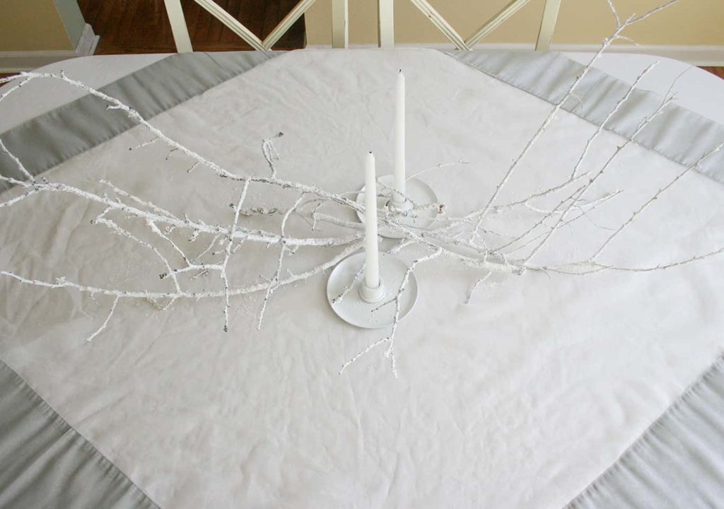 White candle holders and branches