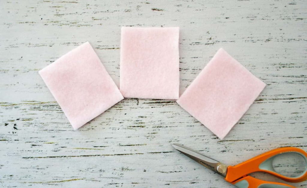3 cut pieces of light pink fleece