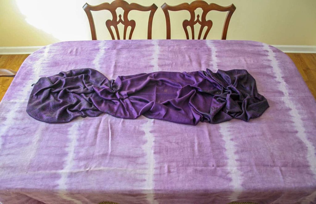 Purple tablecloth and scarf on table