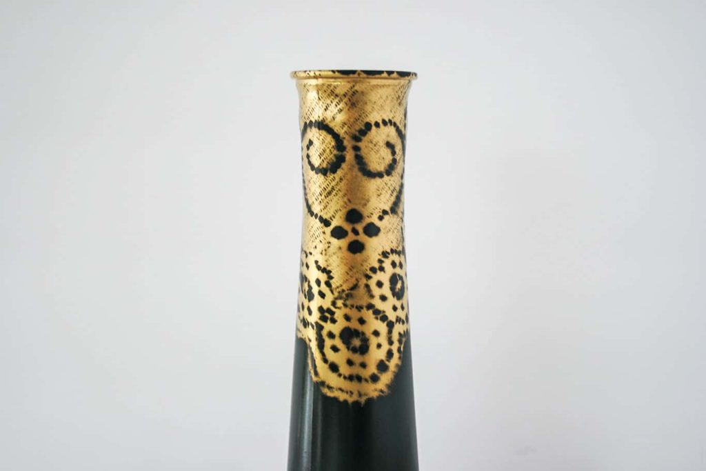 Close up of gold lace imprint on vase