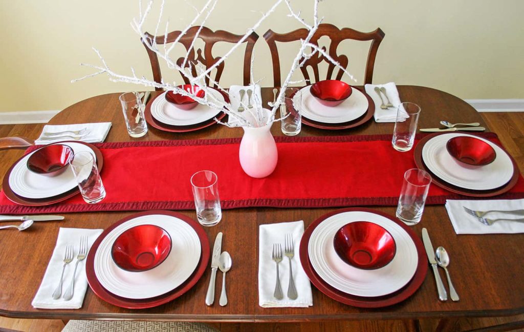 Red bowls and forks added to casual table setting