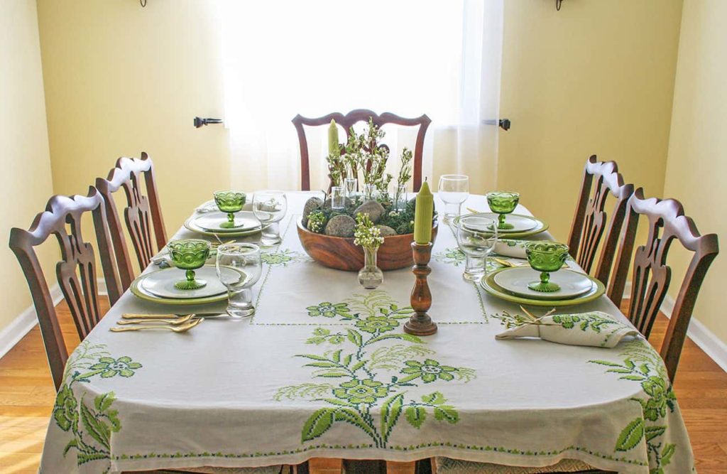 View of green and white tablescape from head of table.