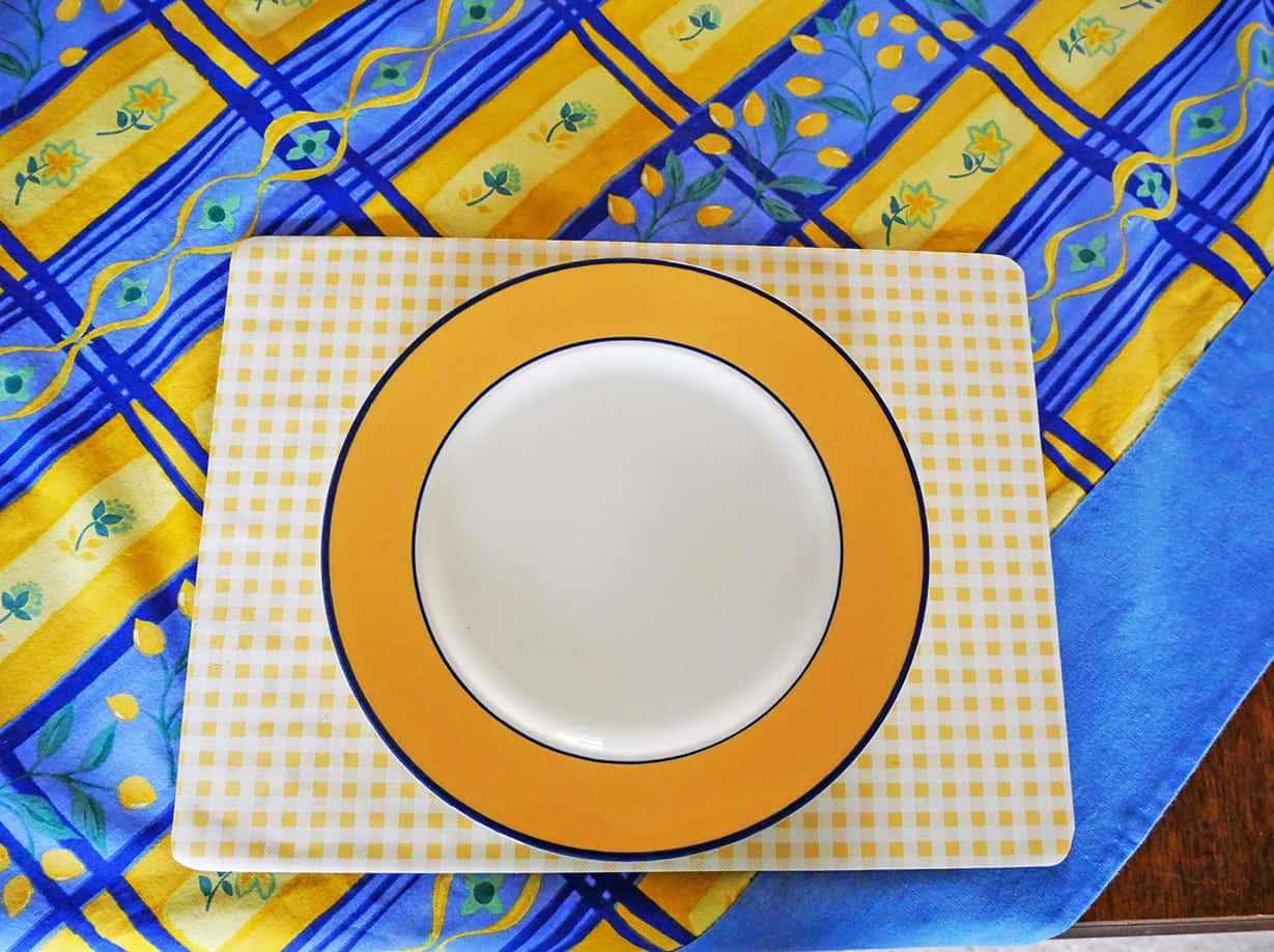 Blue and yellow tablescape for Spring with dinner plate