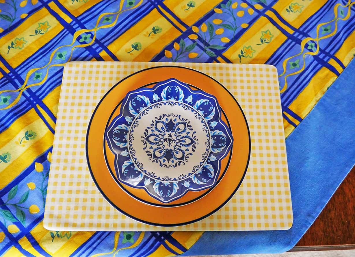 Blue and yellow tablescape for Spring with printed blue plate