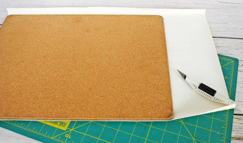 Trim upcycled cork placemat with craft knife