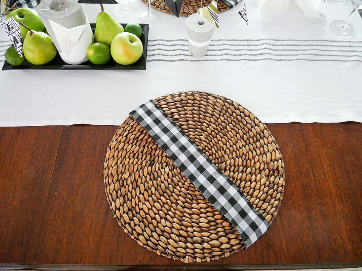 Black and white checkered ribbon across rattan placemat