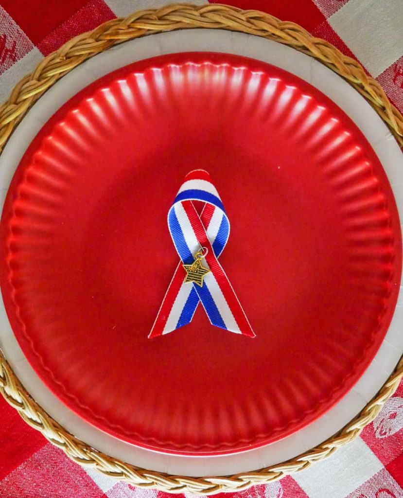 Patriotic pin for Memorial Day table setting n red plate