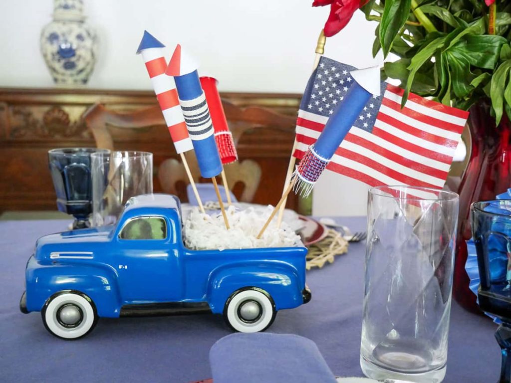 Blue truck with diy fireworks and flag 