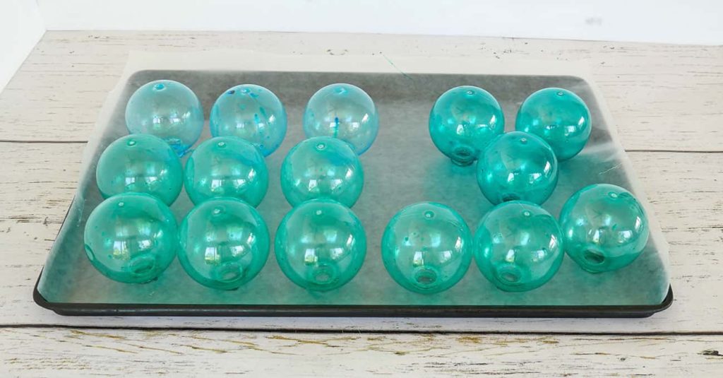 Cookie sheet filled with glass fishing floats