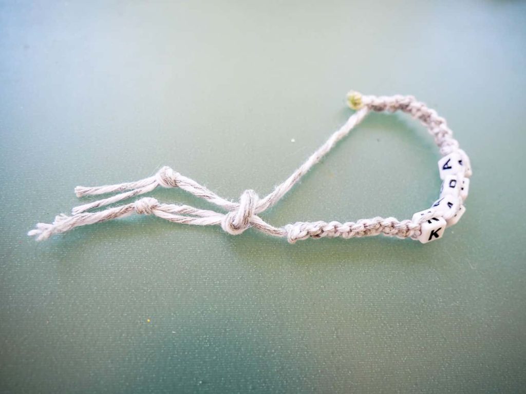 Completed slip knot on diy friendship bracelet napkin ring