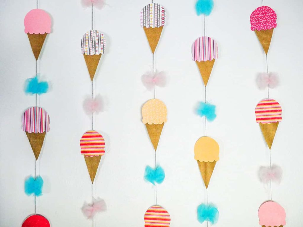 Pattern of ice cream cones and tulle pom poms