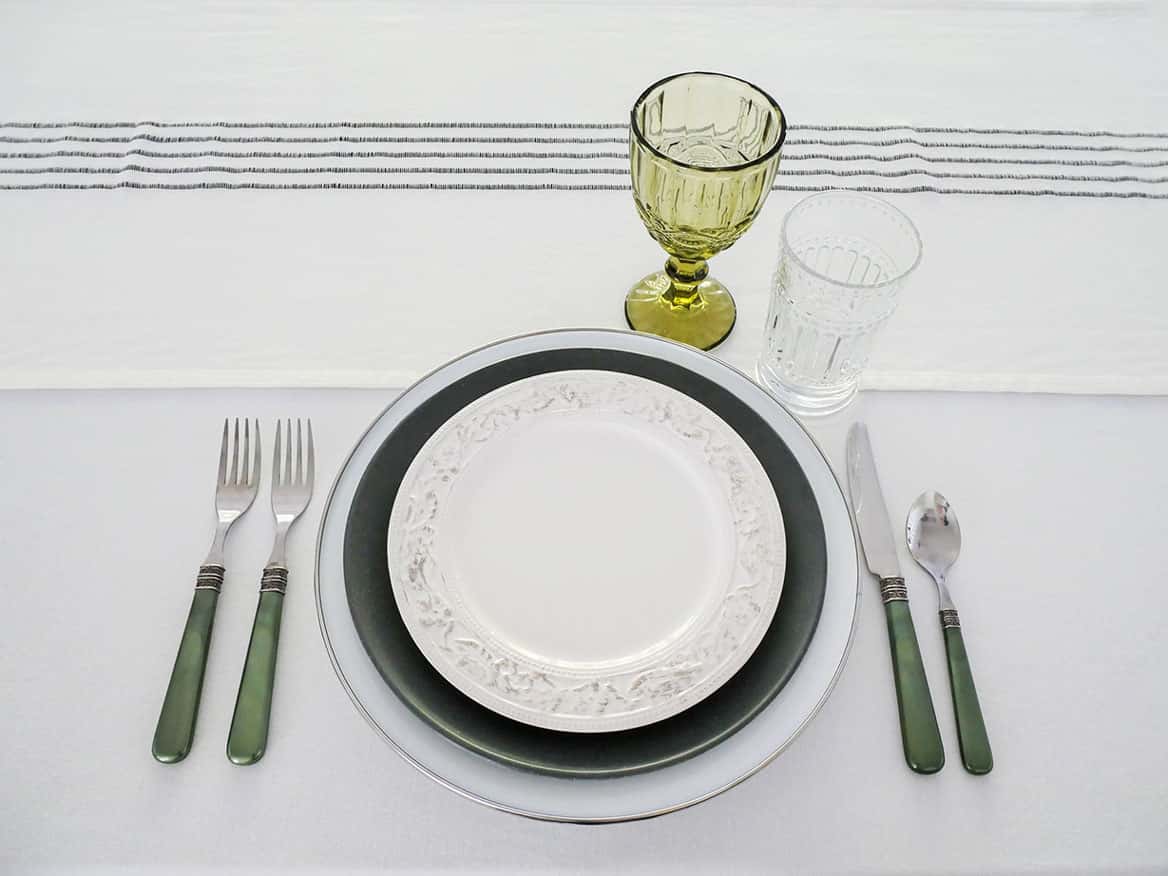 Green and clear glasses added to place setting