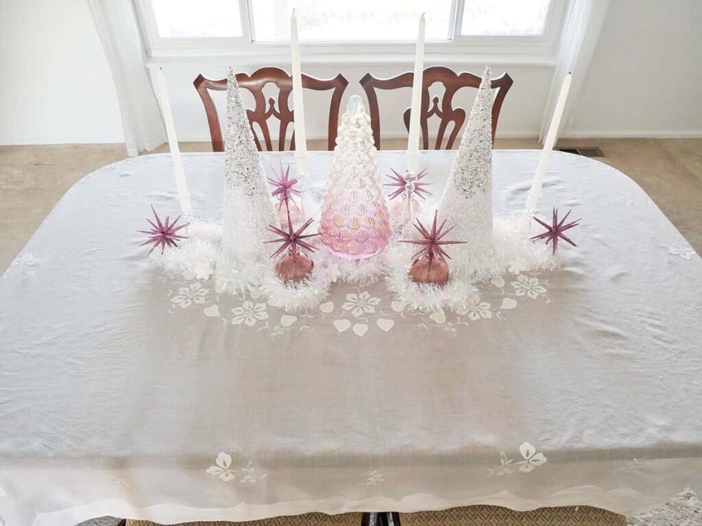 Ornaments and snowflakes added to pretty Christmas table setting