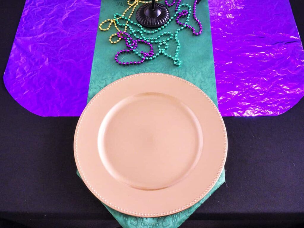 Budget Mardi Gras Tablescape place setting with gold charger