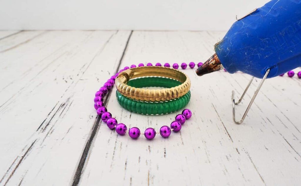 Add beads to Mardi Gras Napkin Rings DIY