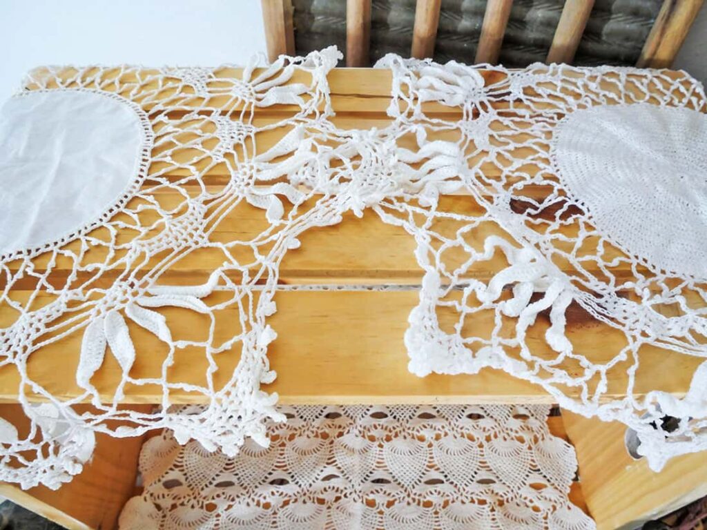 Crocheted doilies on top of wooden crate.