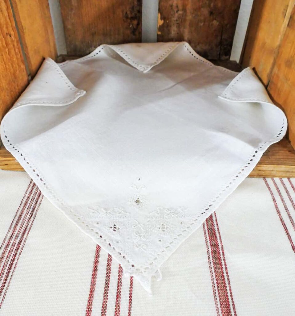 Napkin with embroidered detail on rustic farmhouse buffet table setup