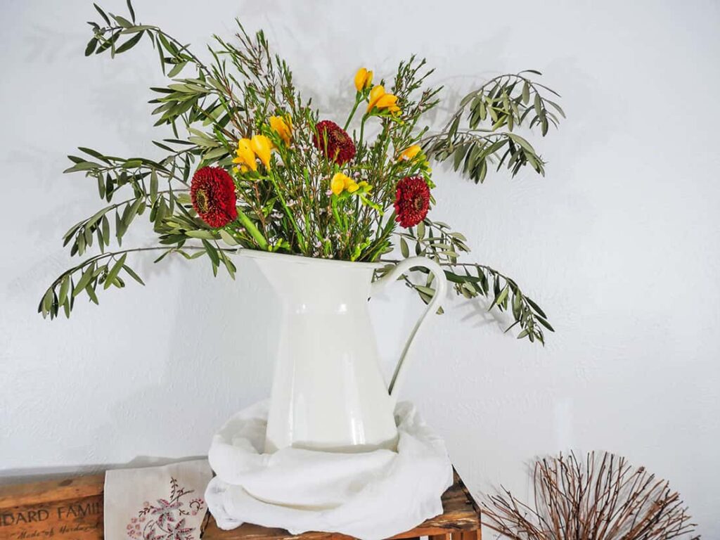 Flowers in a white farmhouse style pitcher