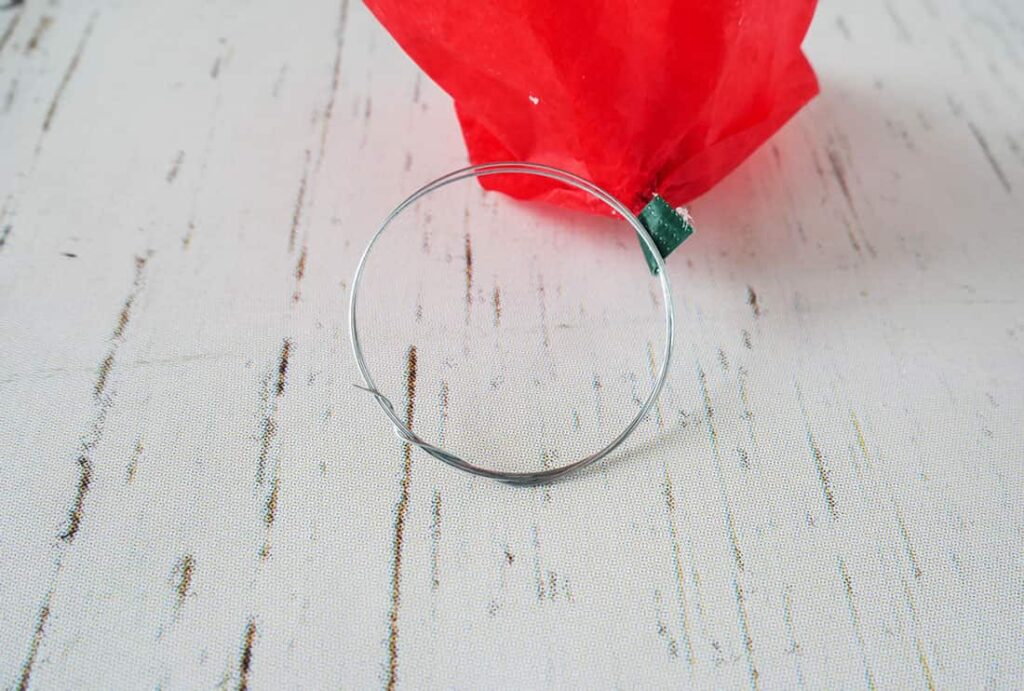 DIY red poppy napkin rings with wire wrapped around end