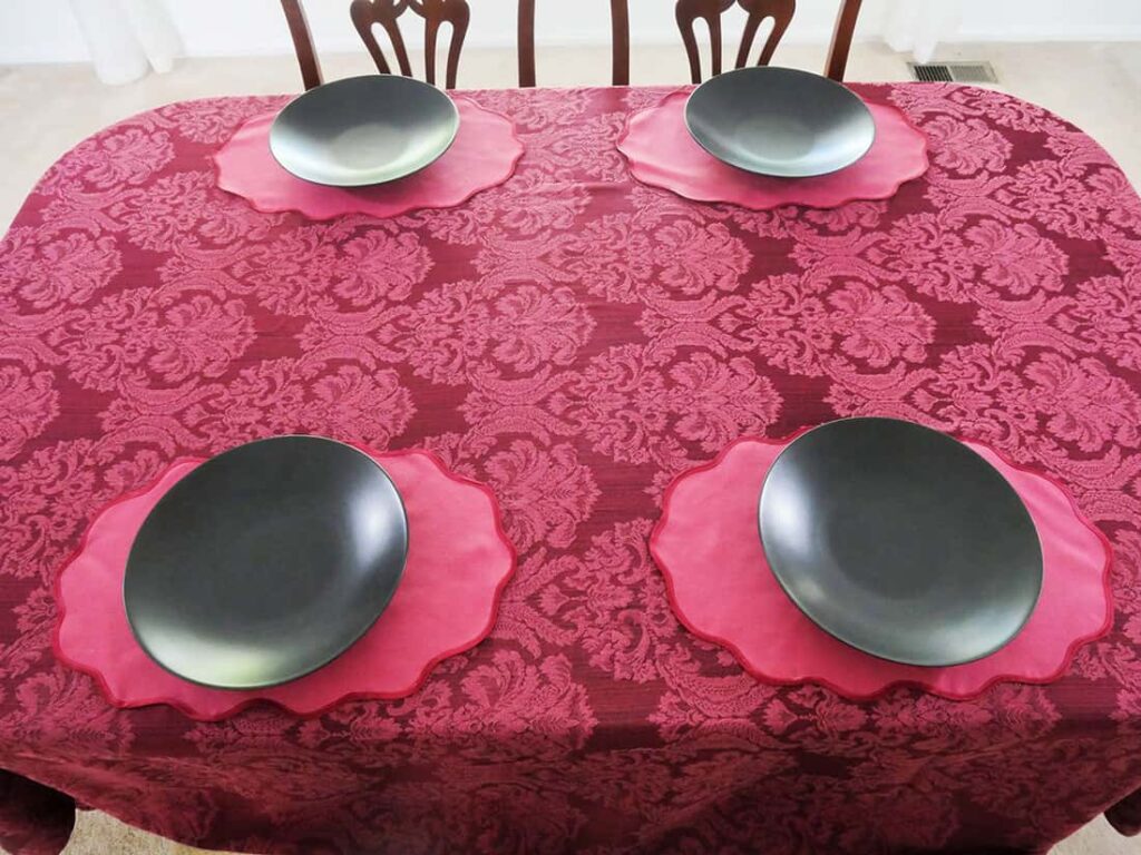 Black plates on moody maximalism tablescape