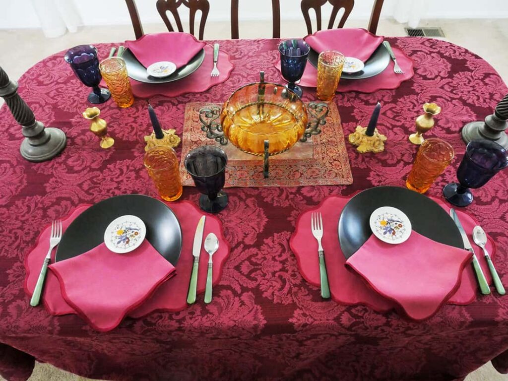 Candle holders, and vases added to middle of table setting