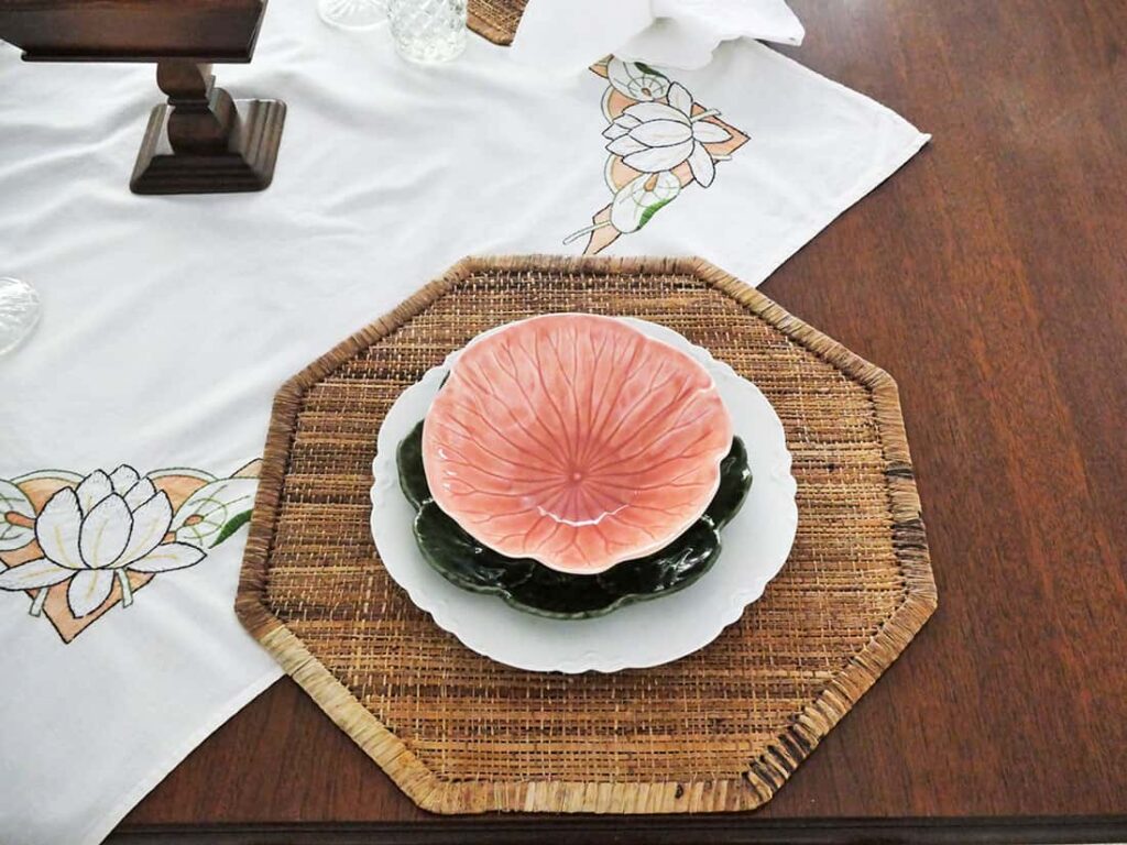 Peach color bowl placed on top green plate