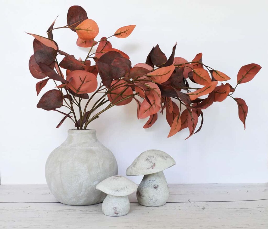 Rust colored stems in concrete vase