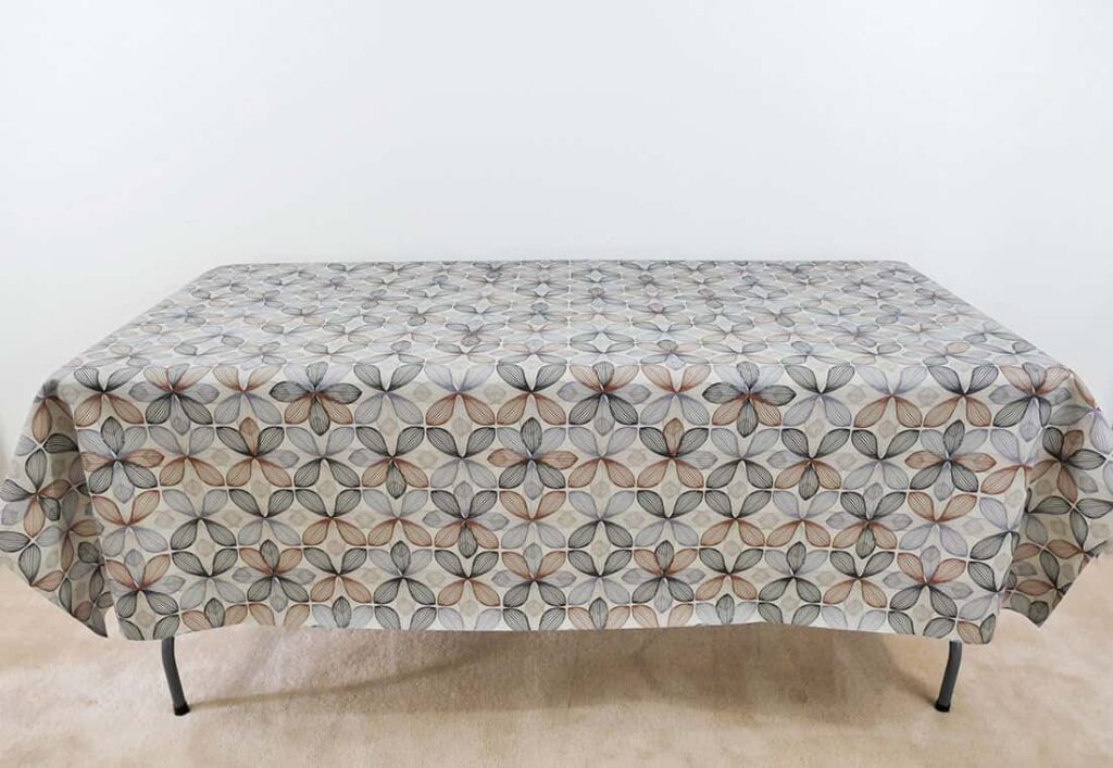 Folding table covered with vinyl tablecloth