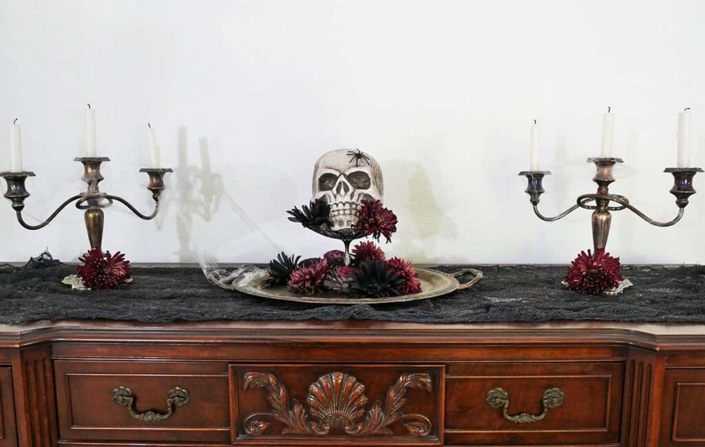 Spooky Halloween decor on buffet table.