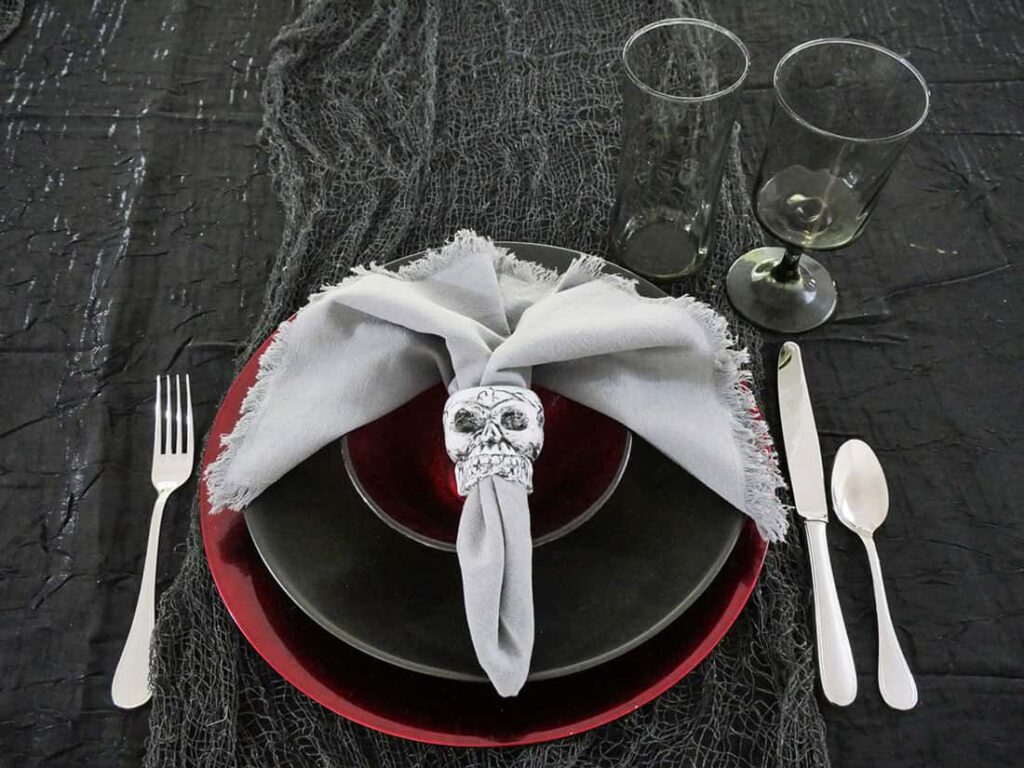 DIY skull napkin ring added to spooky Halloween place setting.