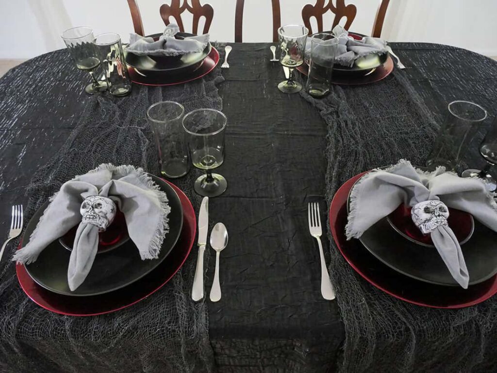 Spooky Halloween skeleton tablesape with place settings.