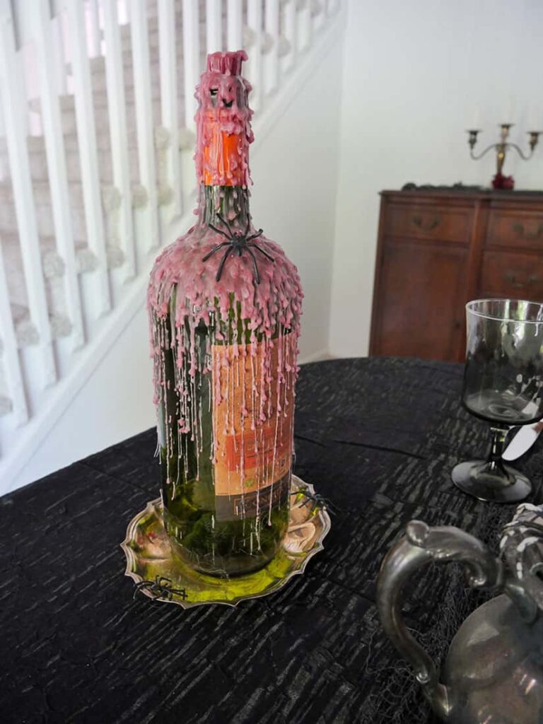 Close up of wine bottle with melted candle wax.