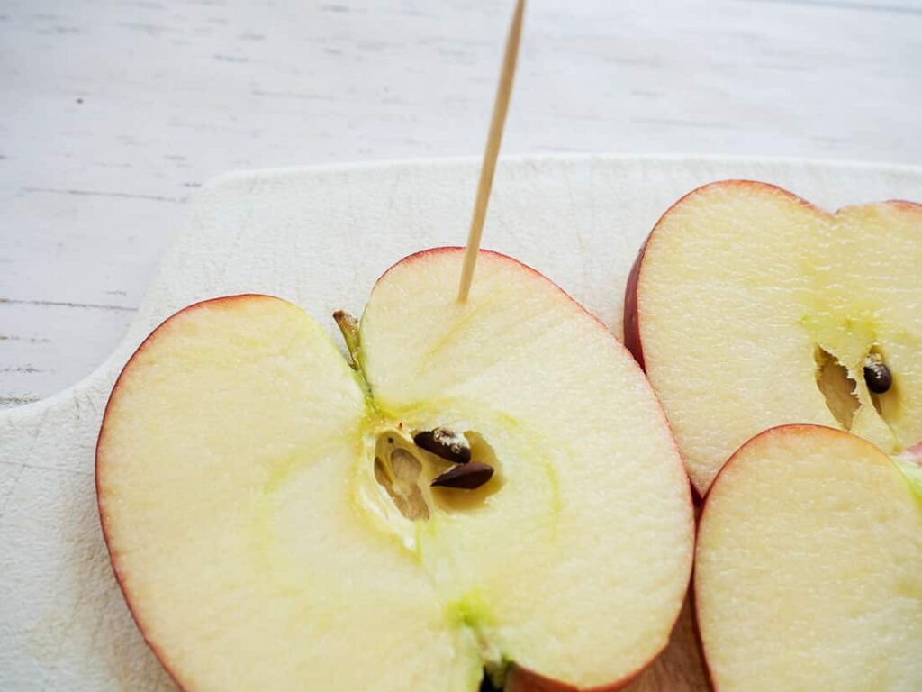 Close up of toothpick in apple.
