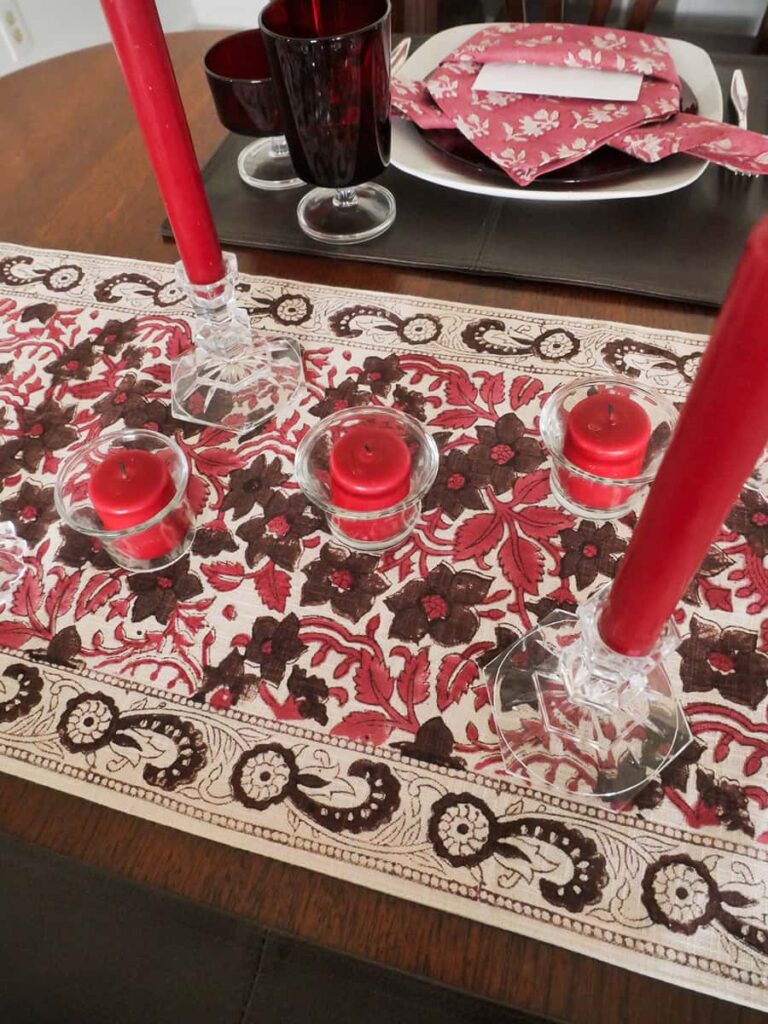 Overhead view of candles on table runner.