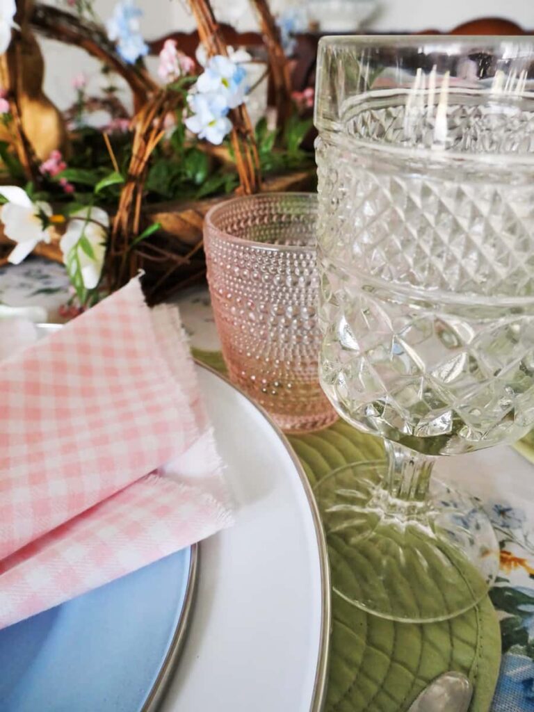 Pink and clear glasses on Easter table setting.