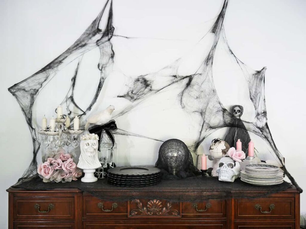 Halloween decorated buffet table with pops of dusty pink.