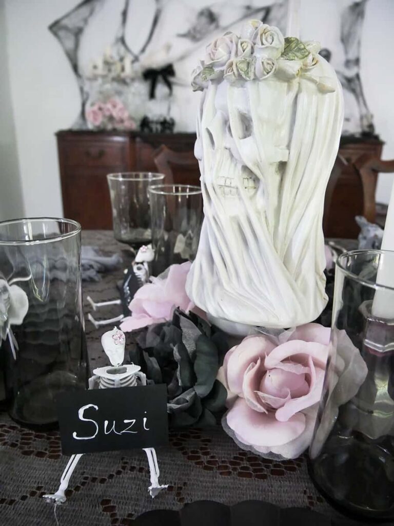 Skeleton bride head with dusty pink flowers at the base.