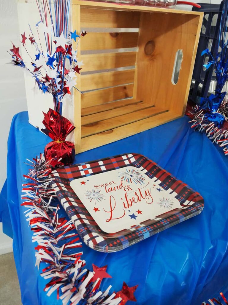 Plates at the front the outdoor buffet table.
