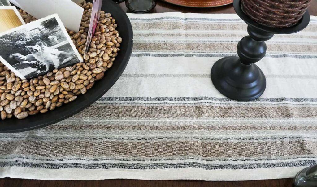 Close up of tan, black and grey striped table runner.