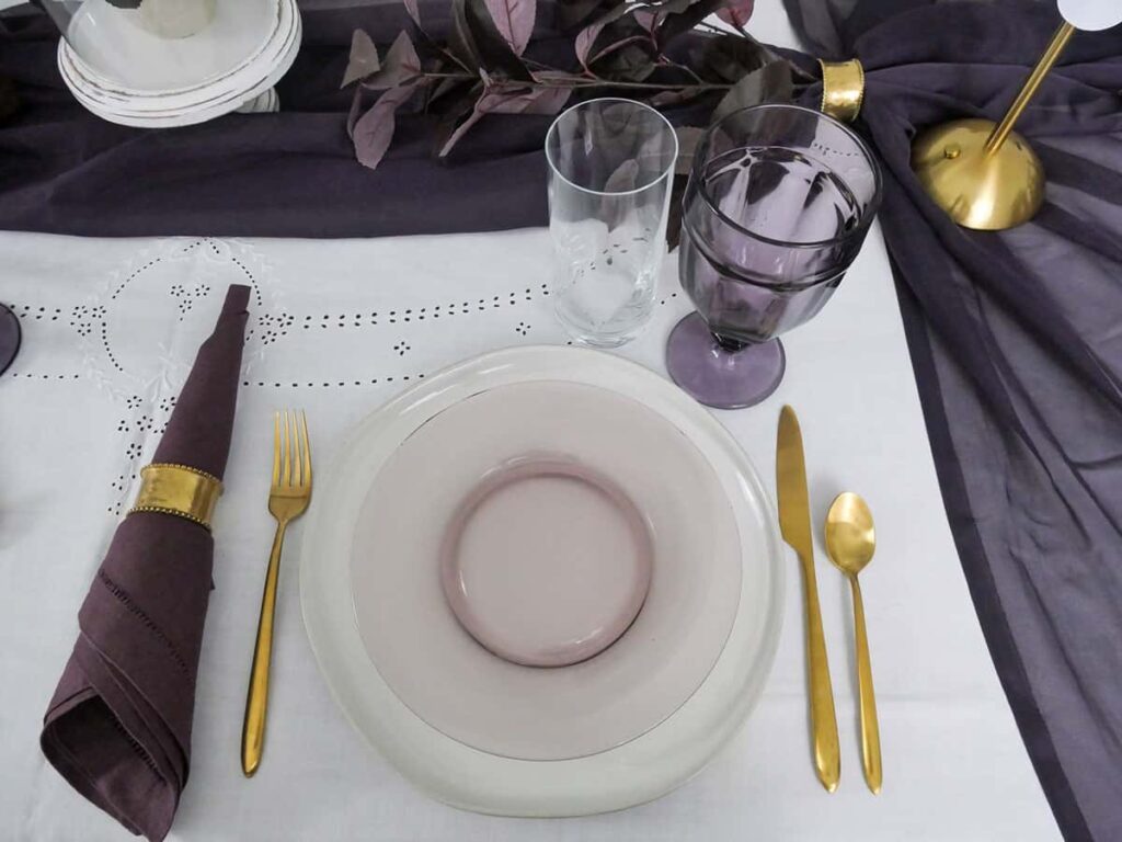 Overhead of a unique fall tablescape with dark purple napkins.