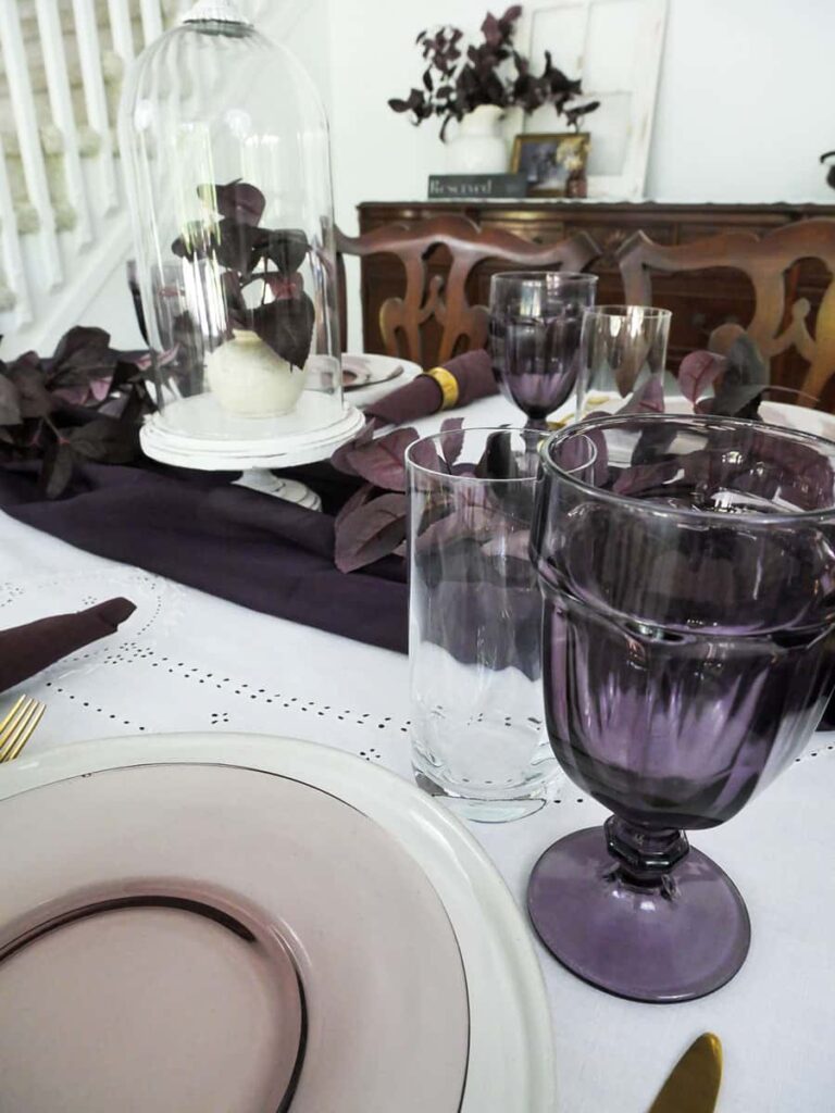Festive fall tablescape using dark purple and white.