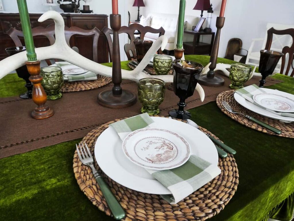 Simple Fall table setting using rattan chargers, white plates and green checkered napkins.