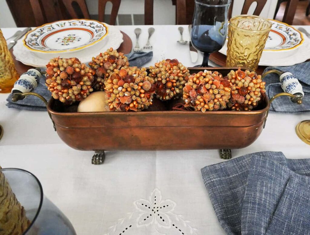 Close up of a vintage copper planter filled with shinny balls.
