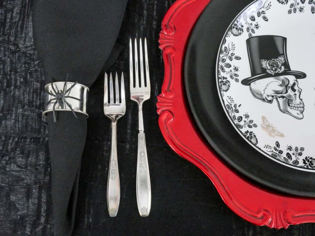 Fake spider placed on silver napkin ring.