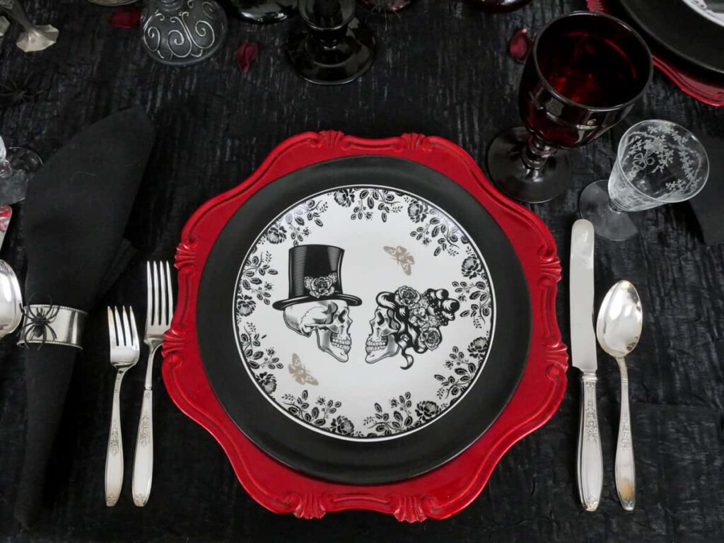 Overhead view of an elegant Halloween tablescape's place settings.