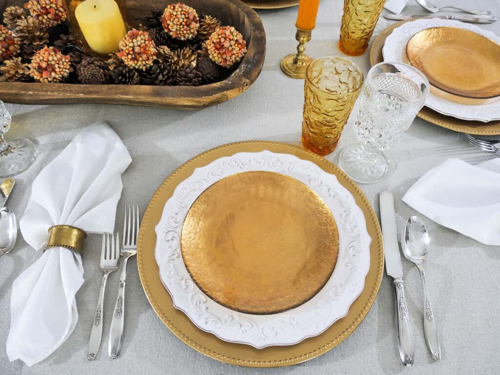 Overhead view of gold and white fall tablescape.